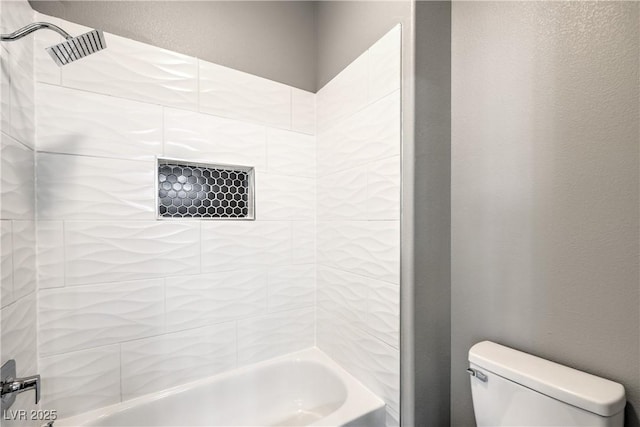 full bathroom with shower / tub combination, toilet, and a textured wall