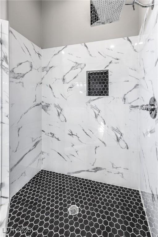 full bath with a marble finish shower