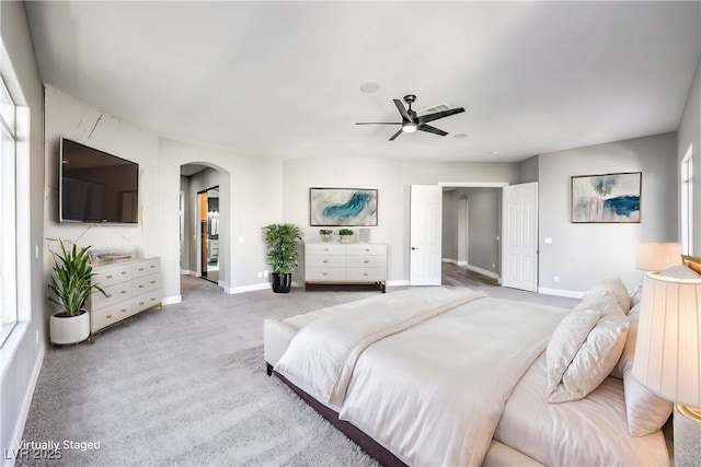 8864 La Manga Ave, Las Vegas, NV 89147 - carpeted bedroom with arched walkways, a ceiling fan, and baseboards