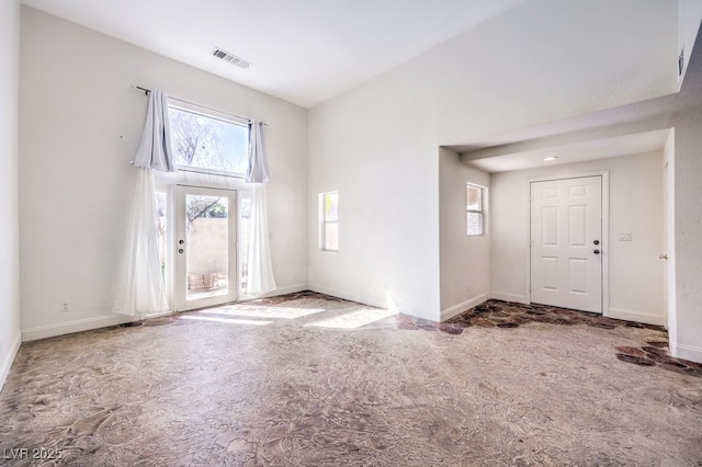 foyer featuring carpet flooring, baseboards, and visible vents