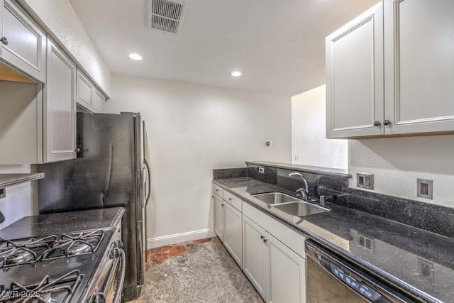 kitchen featuring visible vents, a sink, dark stone countertops, black dishwasher, and gas stove