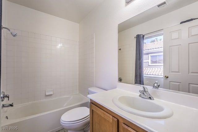 bathroom featuring vanity, shower / bath combo with shower curtain, toilet, and visible vents