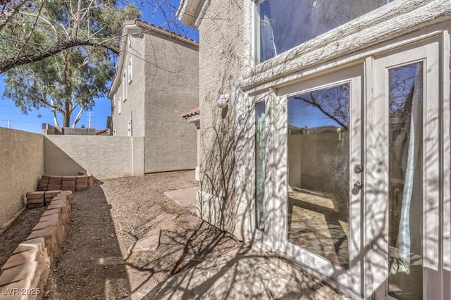 exterior space with stucco siding and a fenced backyard