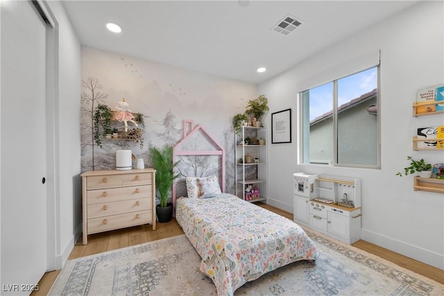 bedroom featuring recessed lighting, wood finished floors, visible vents, and baseboards