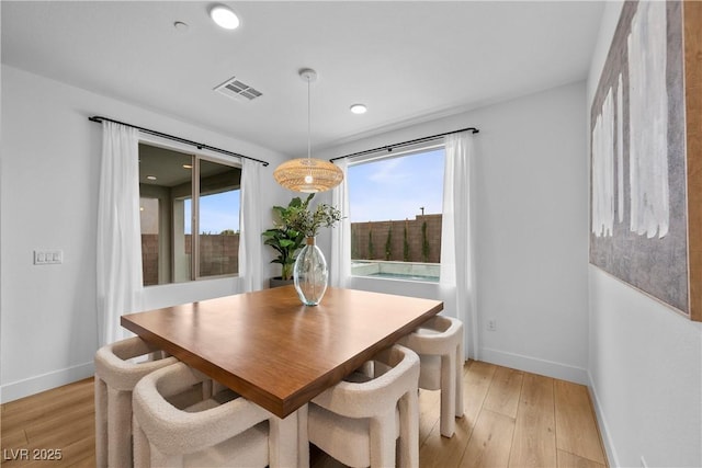 dining space featuring visible vents, baseboards, and light wood-style floors