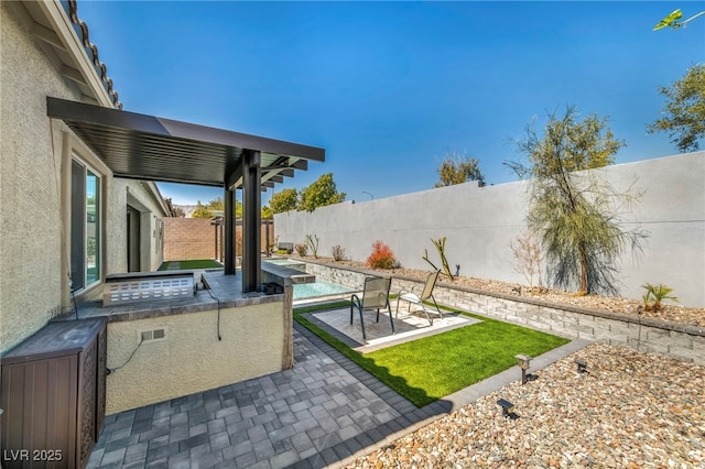 view of yard featuring a patio area, a fenced in pool, a fenced backyard, and an outdoor kitchen