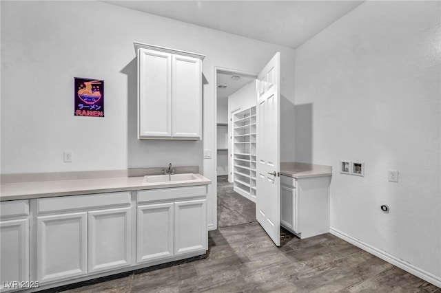 clothes washing area with washer hookup, cabinet space, dark wood-style flooring, and a sink