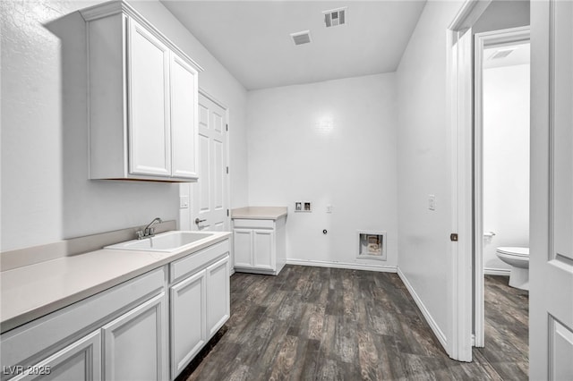 laundry area with electric dryer hookup, visible vents, washer hookup, a sink, and cabinet space