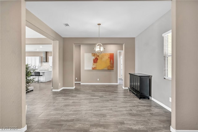 dining room with plenty of natural light, baseboards, visible vents, and a chandelier