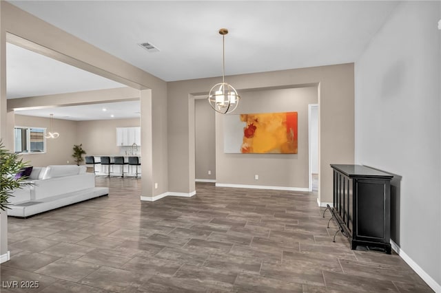 dining area with a notable chandelier, baseboards, and visible vents