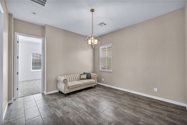 sitting room with a notable chandelier, a healthy amount of sunlight, and visible vents