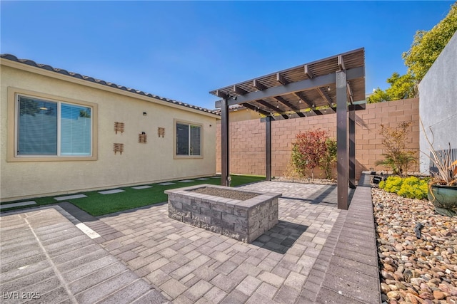 view of patio / terrace with fence, a pergola, and a fire pit