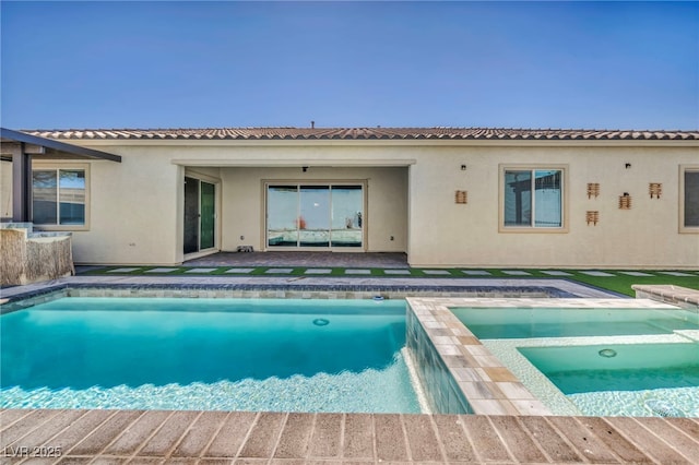 outdoor pool featuring a patio and an in ground hot tub