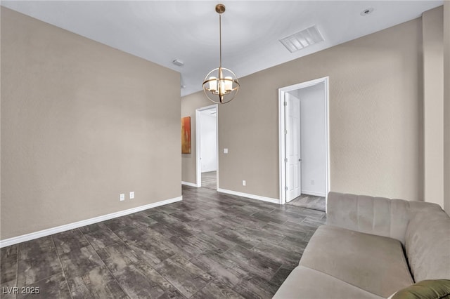 unfurnished living room with visible vents, baseboards, dark wood-type flooring, and a notable chandelier