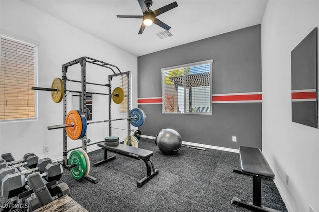 exercise area with visible vents, baseboards, and ceiling fan