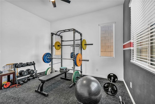 exercise room featuring a ceiling fan and baseboards