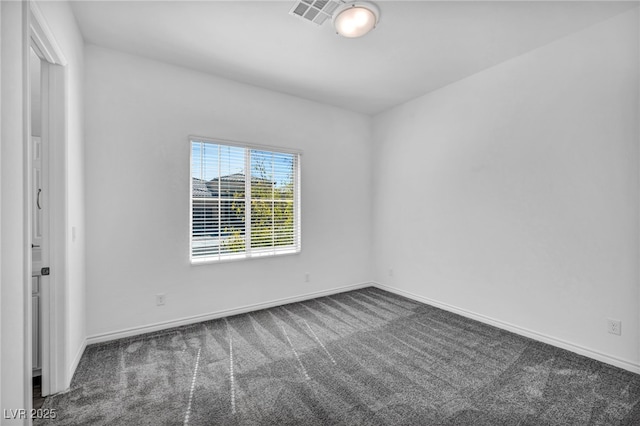 carpeted empty room with visible vents and baseboards