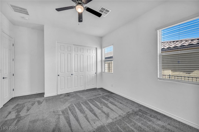 unfurnished bedroom featuring visible vents, baseboards, carpet, and a closet