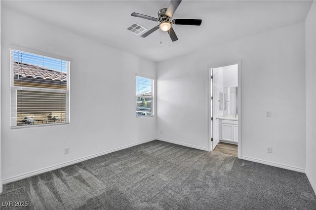 unfurnished bedroom featuring baseboards, visible vents, ceiling fan, carpet flooring, and connected bathroom