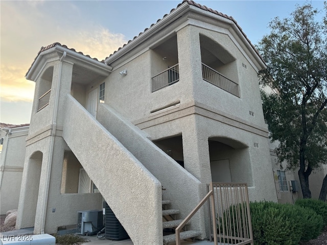 1881 W Alexander Rd Unit 2095, North Las Vegas, NV 89032 - back of house featuring stucco siding, central air condition unit, a balcony, and a tile roof