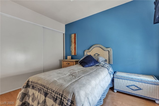 bedroom with a closet and wood finished floors