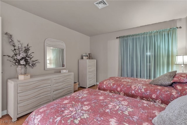 bedroom featuring visible vents, baseboards, and light wood-style floors