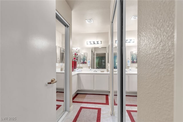 bathroom featuring vanity and visible vents