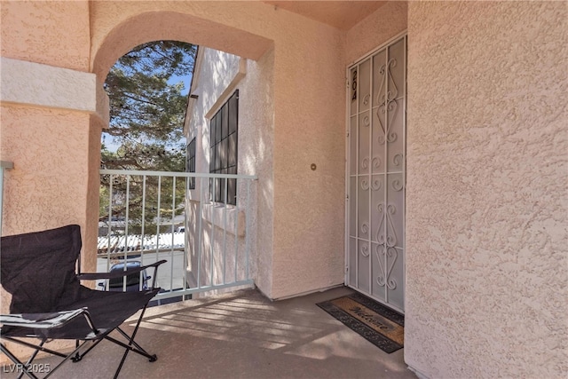 property entrance with stucco siding