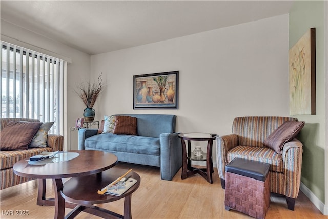 living room with baseboards and light wood finished floors