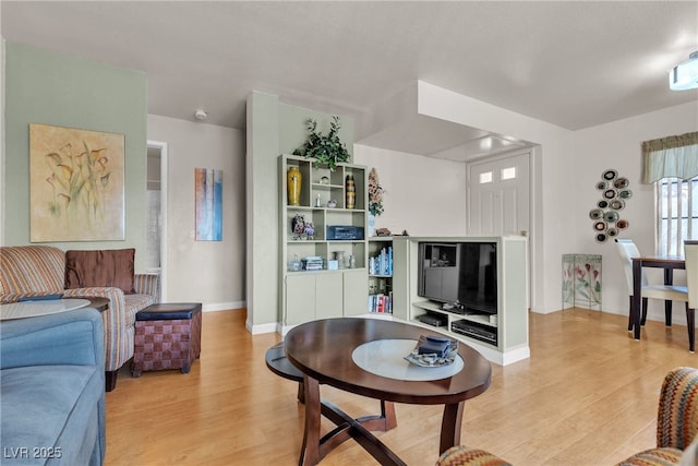 living room with light wood-style floors and baseboards