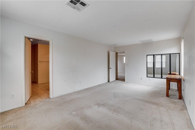carpeted empty room with visible vents