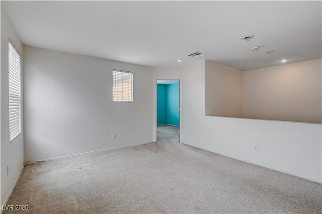 empty room with carpet floors, visible vents, and recessed lighting