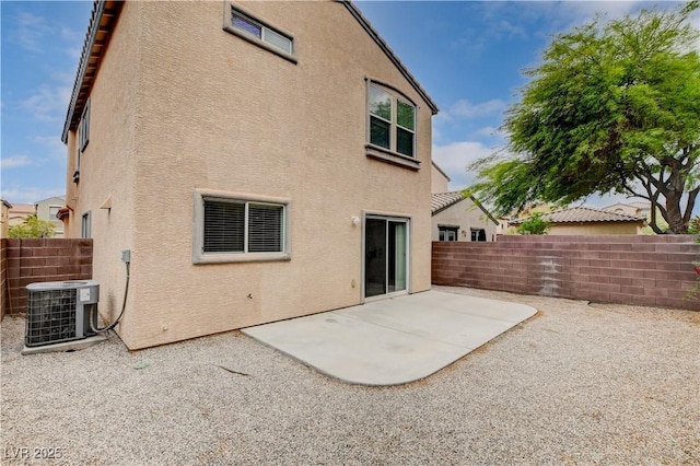 back of property featuring central AC unit, stucco siding, a patio area, and a fenced backyard