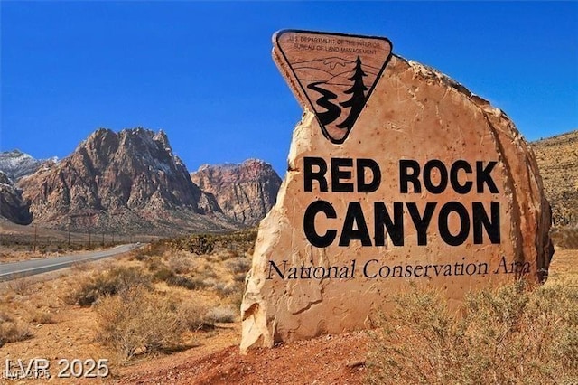 community sign with a mountain view