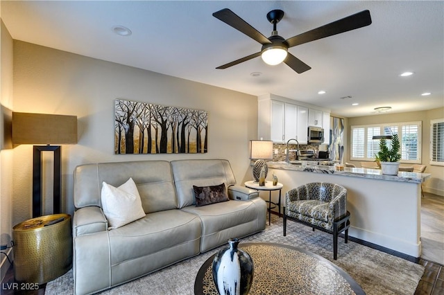 living area featuring recessed lighting and a ceiling fan