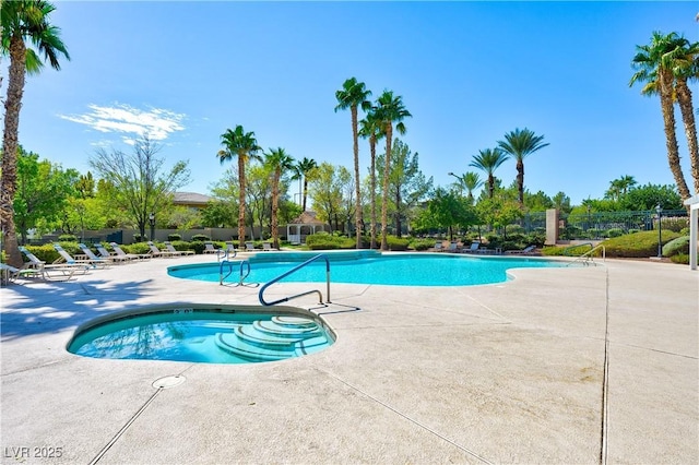 community pool featuring a patio and fence