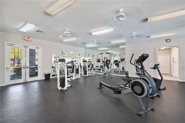 workout area with visible vents, a ceiling fan, french doors, arched walkways, and baseboards