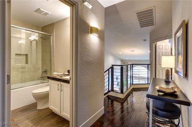 bathroom featuring visible vents, wood finished floors, and vanity