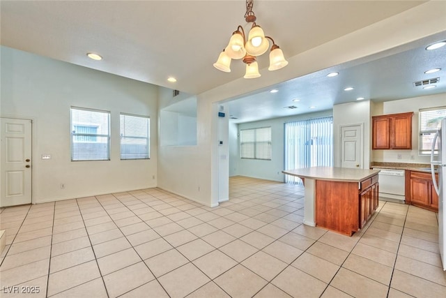 kitchen featuring dishwasher, light countertops, light tile patterned flooring, and visible vents