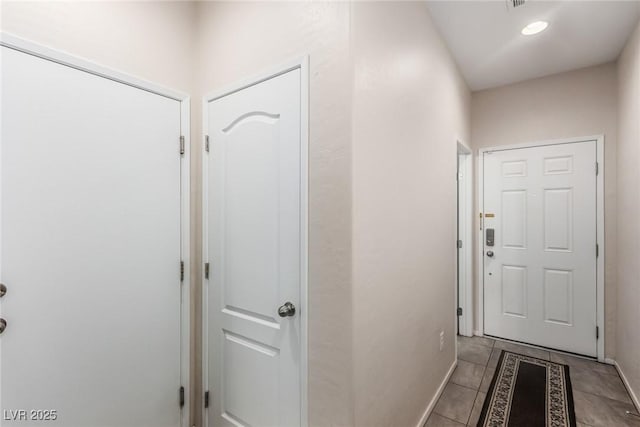 interior space featuring light tile patterned floors and baseboards