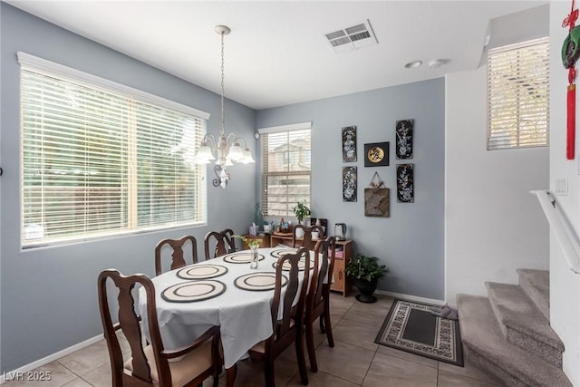 dining space featuring visible vents, light tile patterned floors, baseboards, a chandelier, and stairs