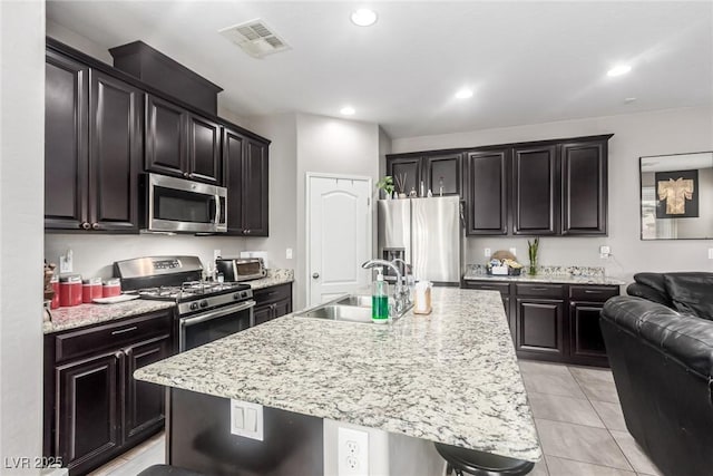 kitchen with visible vents, an island with sink, recessed lighting, appliances with stainless steel finishes, and a sink