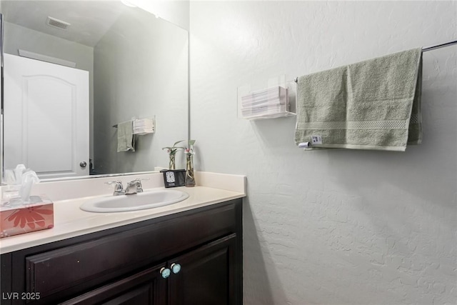 bathroom with visible vents and vanity