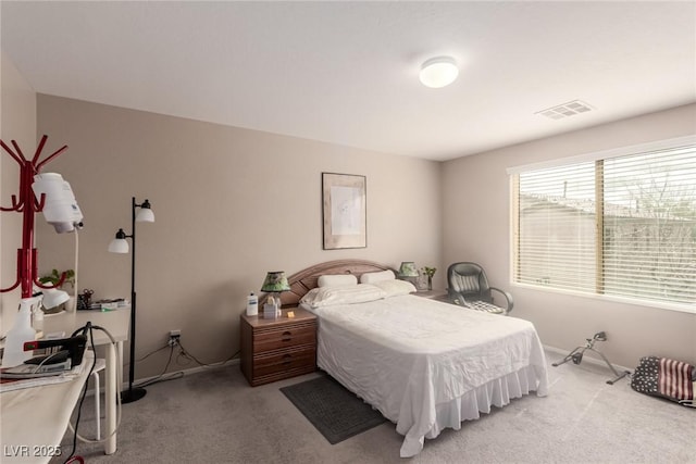 bedroom with visible vents, baseboards, and carpet