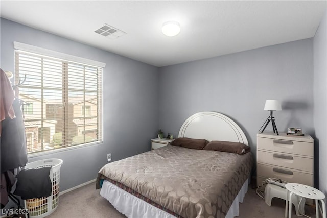 carpeted bedroom with visible vents and baseboards