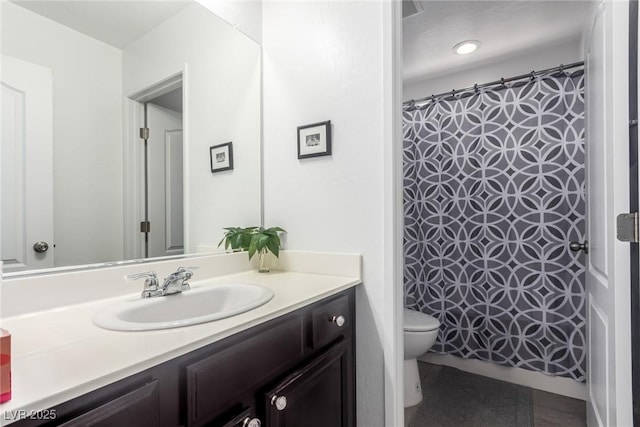 full bath with vanity, curtained shower, and toilet