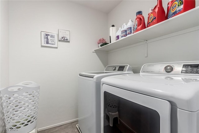 laundry room featuring washing machine and clothes dryer, laundry area, and tile patterned flooring