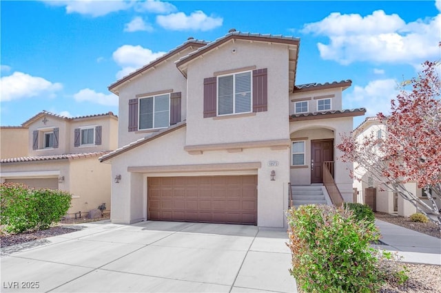 mediterranean / spanish-style house featuring a garage, driveway, and stucco siding