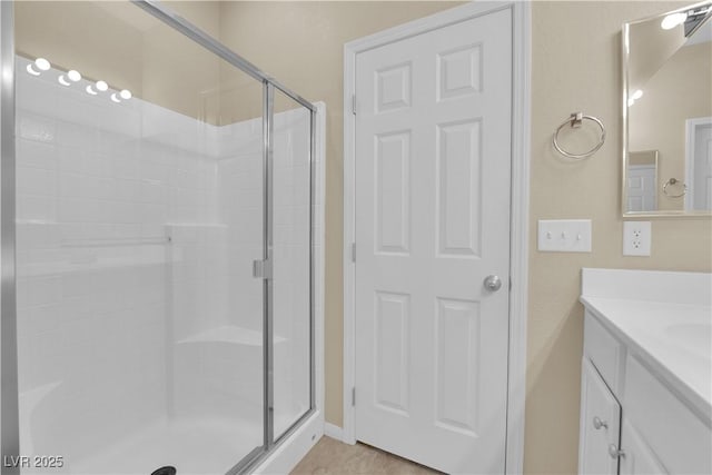 full bathroom with vanity and a stall shower