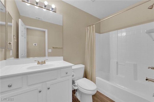 bathroom featuring vanity, wood finished floors, shower / bathtub combination with curtain, visible vents, and toilet